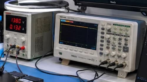 Bench power supply and oscilloscope monitoring a module under test